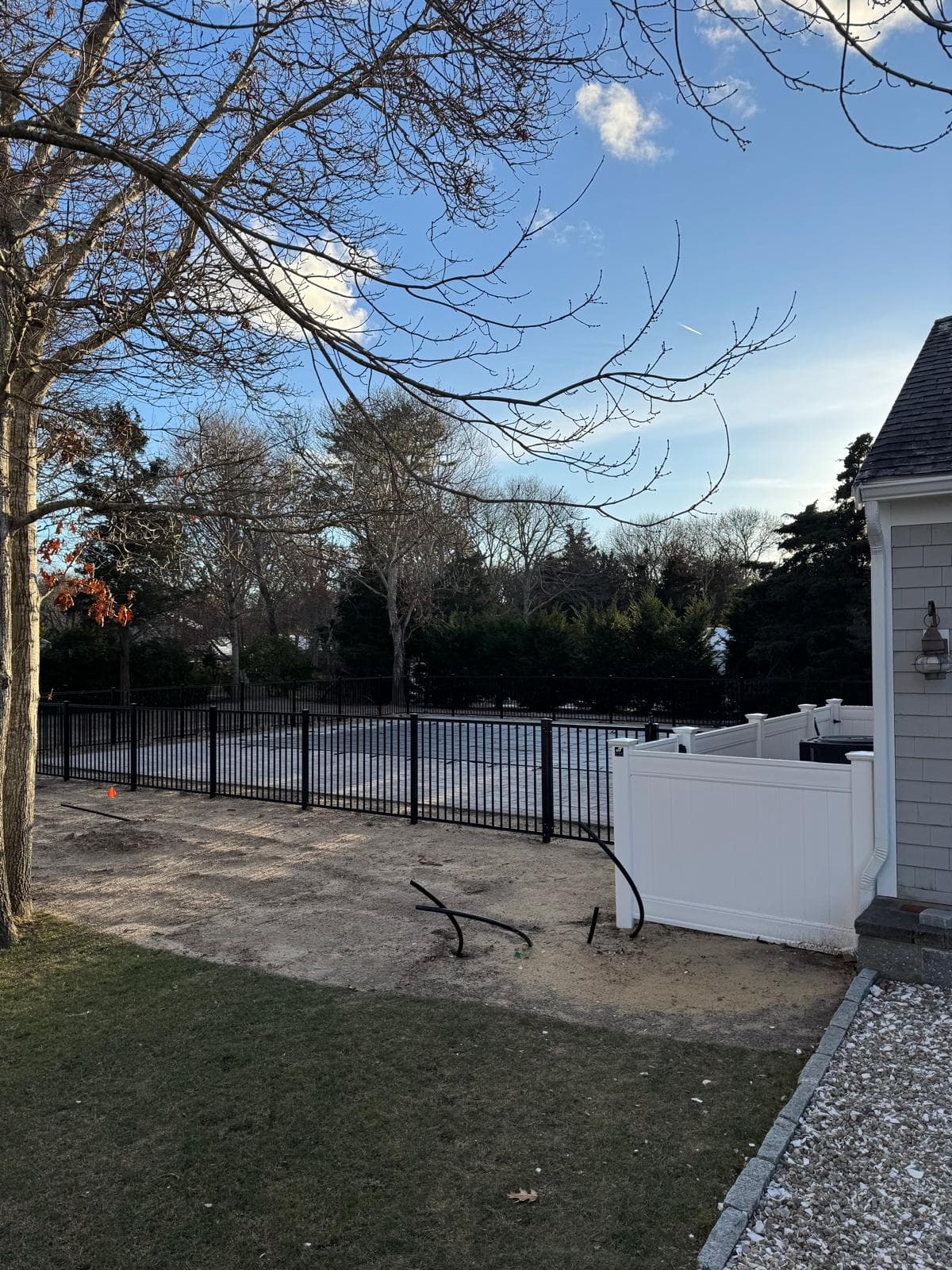 Black aluminum with white vinyl along property line — hybrid design