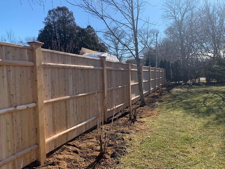 Custom wood fencing with professional post setting and straight fence line, South Shore Massachusetts